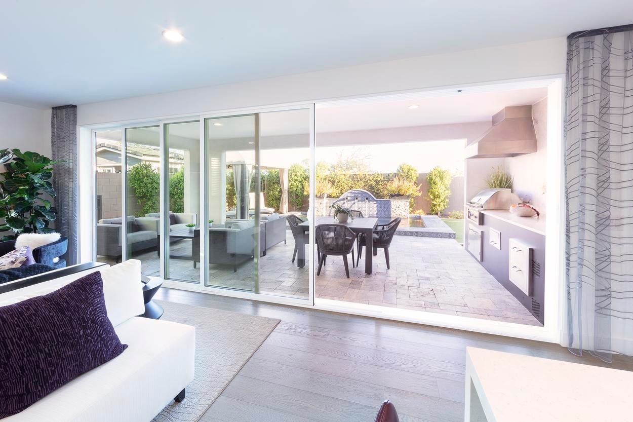 Milgard VX350 vinyl moving glass wall opening to a patio